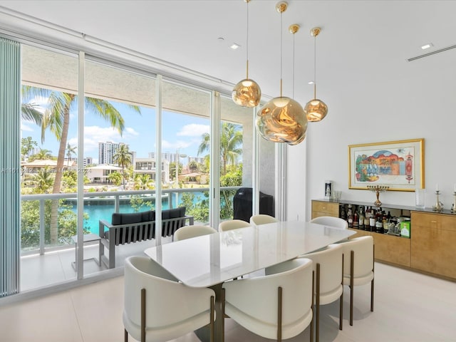 dining area with a wall of windows and a wealth of natural light