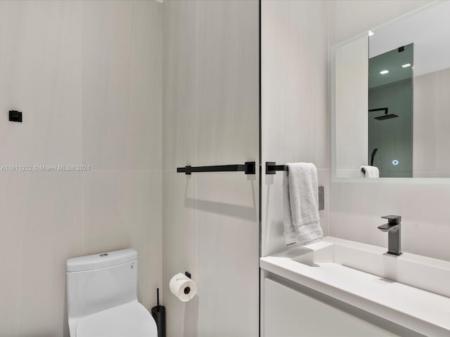 bathroom featuring toilet and vanity