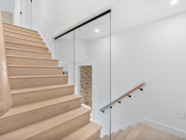 stairs with hardwood / wood-style flooring