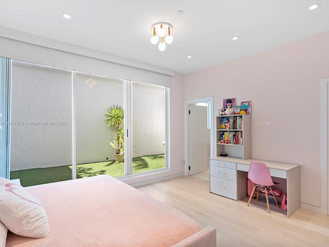 bedroom featuring built in desk and light wood-type flooring