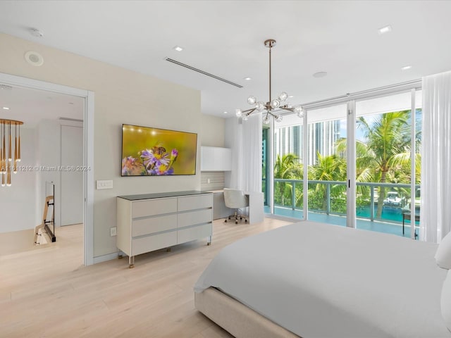 bedroom with light hardwood / wood-style floors, a chandelier, and access to exterior