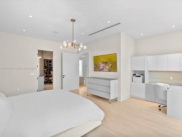 bedroom featuring a notable chandelier and light wood-type flooring