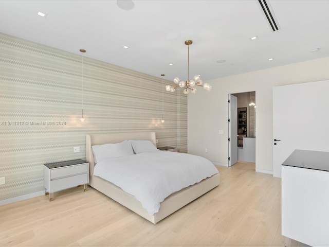 bedroom featuring wood-type flooring and an inviting chandelier