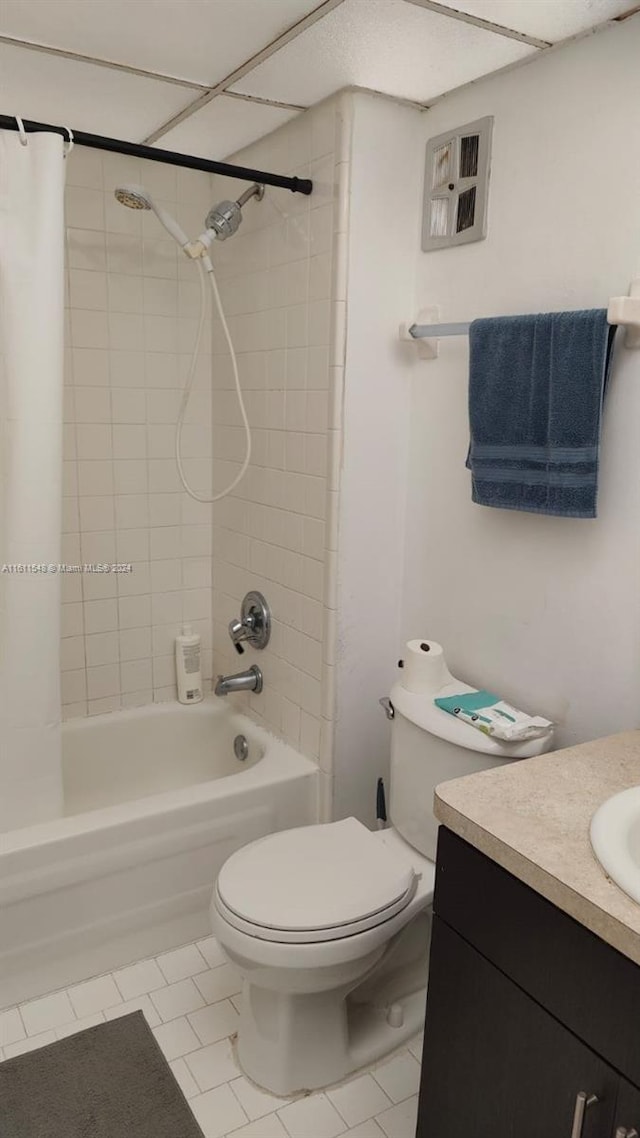 full bathroom featuring tiled shower / bath combo, vanity, toilet, and tile floors