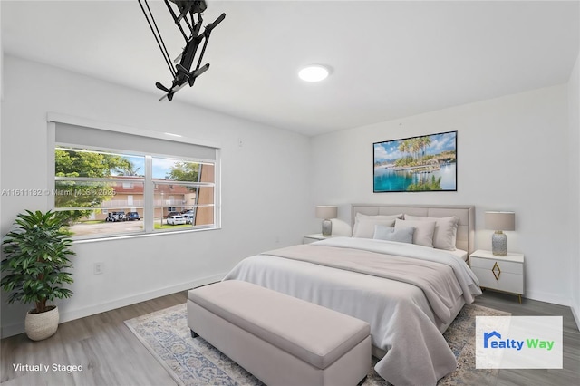 bedroom with hardwood / wood-style floors