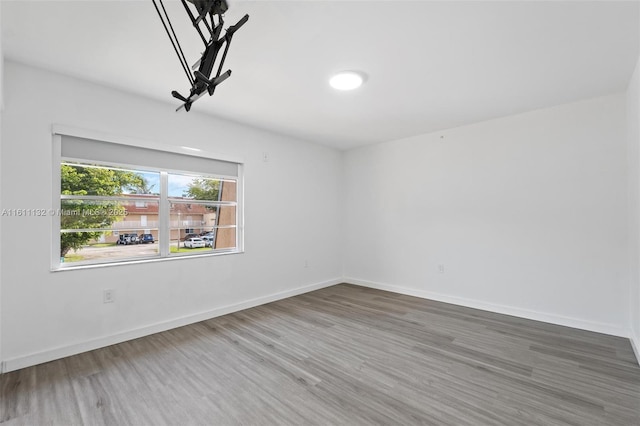 empty room with hardwood / wood-style flooring