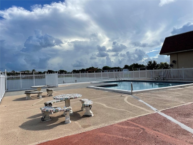 view of swimming pool featuring a patio