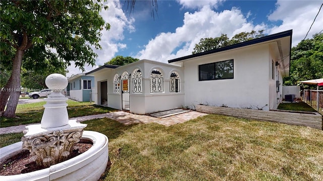 view of front facade with central AC and a front lawn