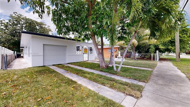 single story home featuring a front yard and a garage