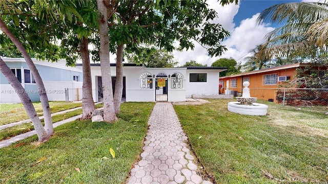 ranch-style home with a front yard