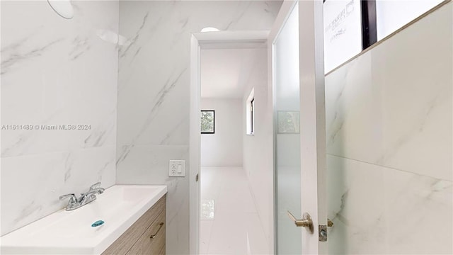 bathroom with tile walls and vanity