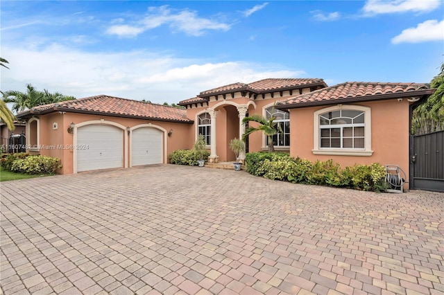 mediterranean / spanish-style house with a garage