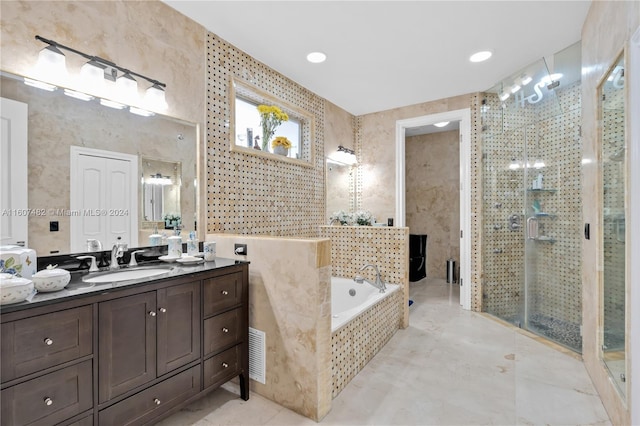 bathroom with tile walls, tile flooring, shower with separate bathtub, and vanity