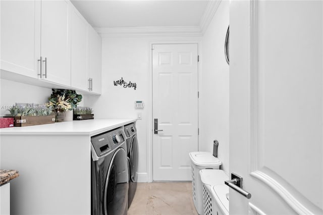 clothes washing area with washing machine and dryer, ornamental molding, cabinets, and light tile floors