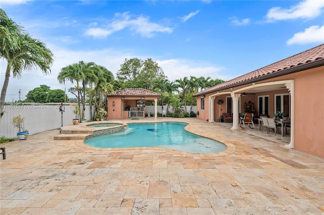 view of pool featuring a patio and an in ground hot tub