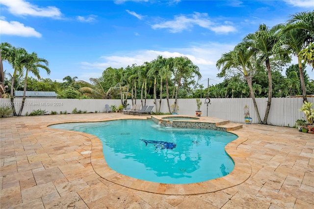 view of pool featuring a patio area and an in ground hot tub