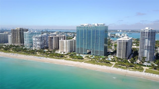 birds eye view of property featuring a water view and a beach view