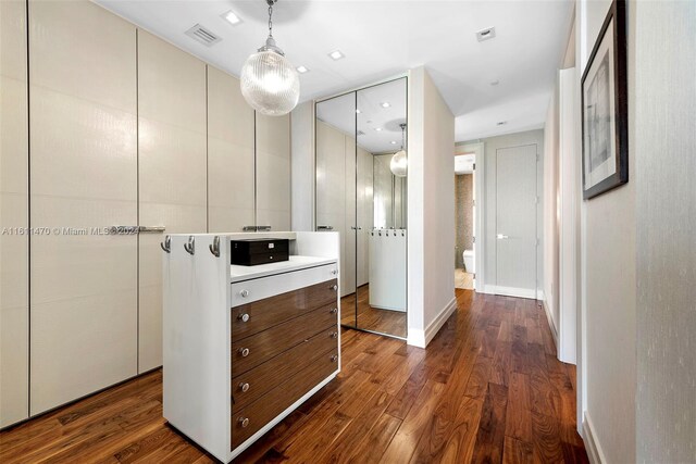 hall with dark wood-type flooring