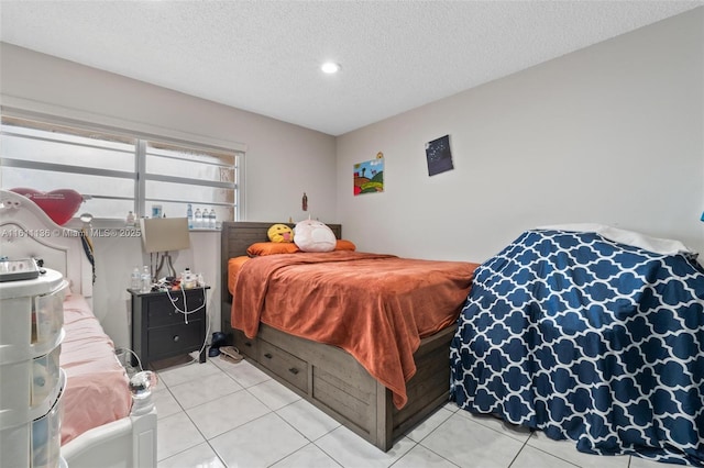 bedroom with light tile patterned floors and a textured ceiling