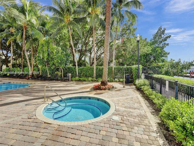 view of pool featuring a community hot tub and a patio