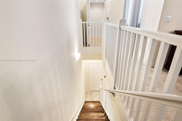 staircase with dark hardwood / wood-style floors