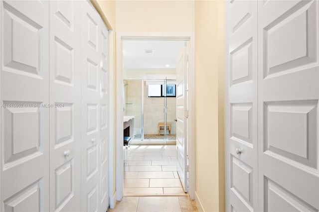 hall with light tile flooring