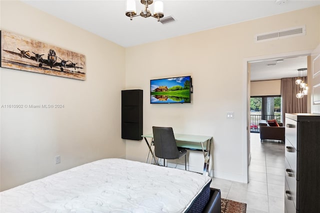 tiled bedroom with a chandelier