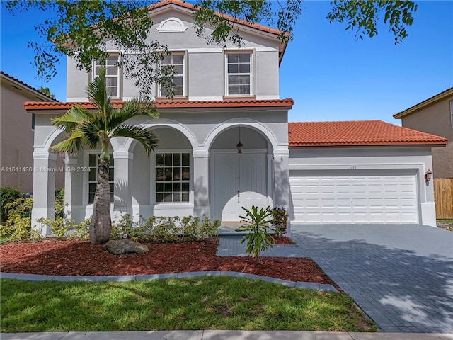 mediterranean / spanish house featuring a garage