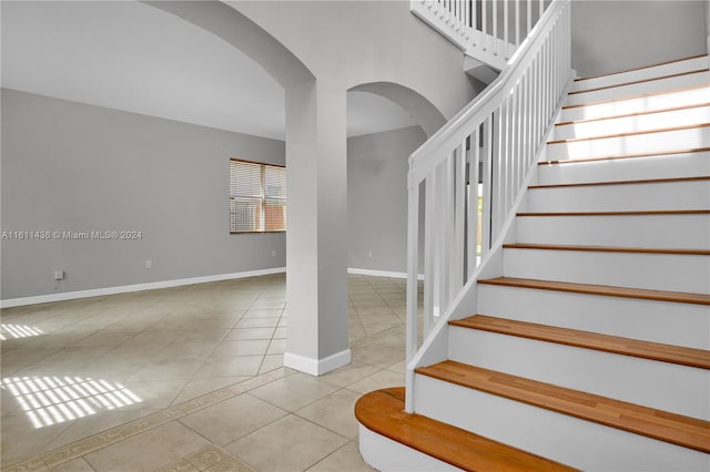 staircase with tile patterned floors