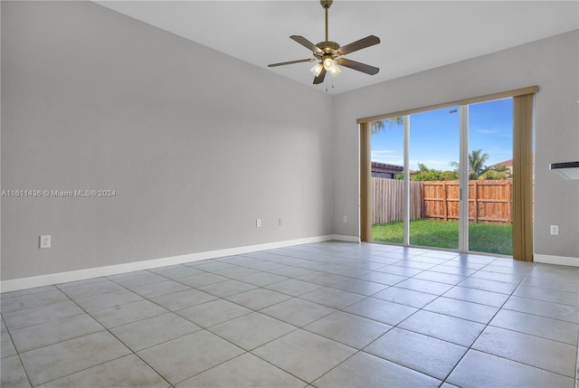 tiled spare room with ceiling fan