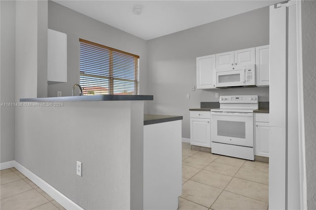 kitchen with white cabinetry, white appliances, and light tile patterned floors