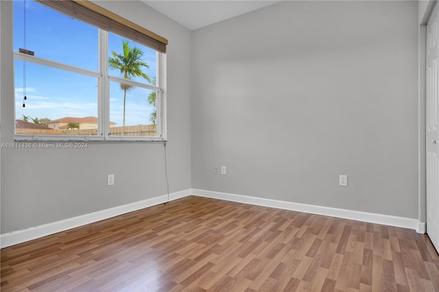 unfurnished room with hardwood / wood-style floors