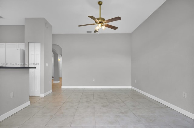 unfurnished living room with ceiling fan and light tile patterned flooring