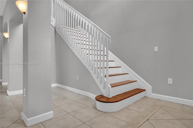 stairs with tile patterned floors