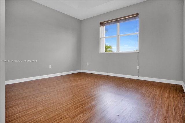 spare room with wood-type flooring