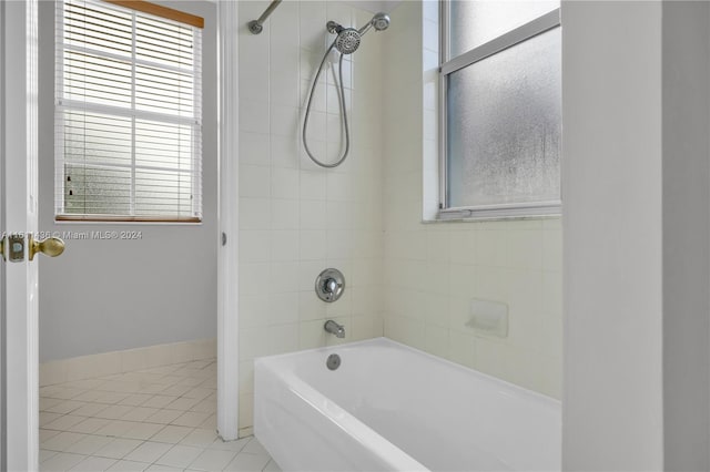 bathroom featuring tile patterned floors and tiled shower / bath