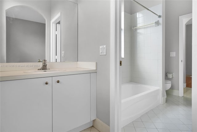 full bathroom featuring tile patterned flooring, vanity, toilet, and tiled shower / bath