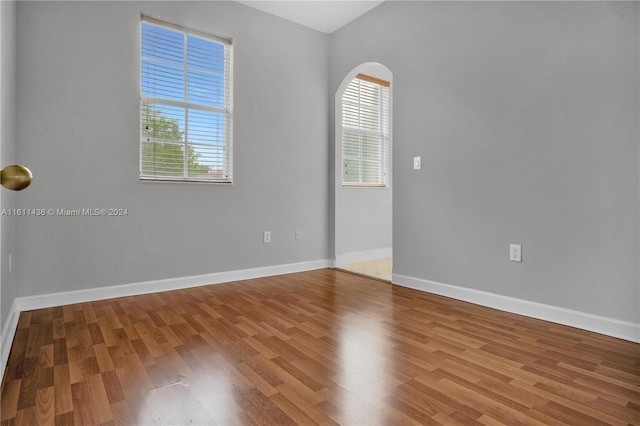 unfurnished room featuring hardwood / wood-style floors and a healthy amount of sunlight