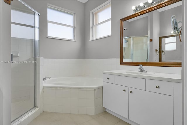 bathroom featuring tile patterned floors, vanity, and separate shower and tub