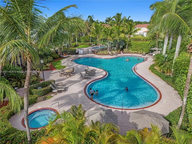 view of swimming pool with a patio area and a community hot tub