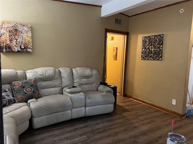 living room with beam ceiling, dark wood-type flooring, and ornamental molding