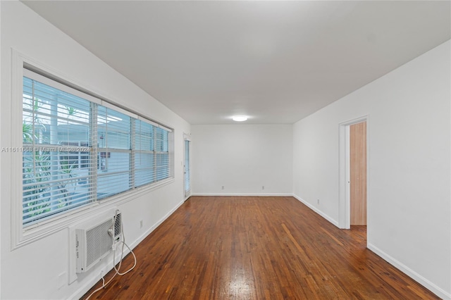 spare room featuring dark wood-type flooring