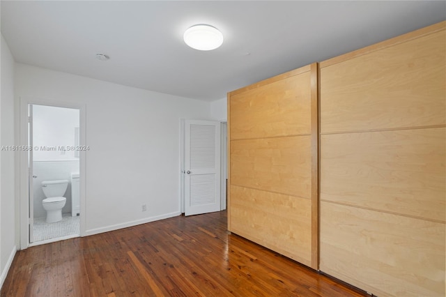 unfurnished bedroom with tile patterned flooring and ensuite bath