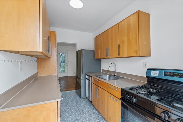 kitchen with sink, black gas range oven, and stainless steel dishwasher