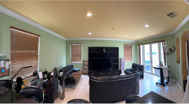 living area with arched walkways, ornamental molding, light tile patterned floors, and visible vents