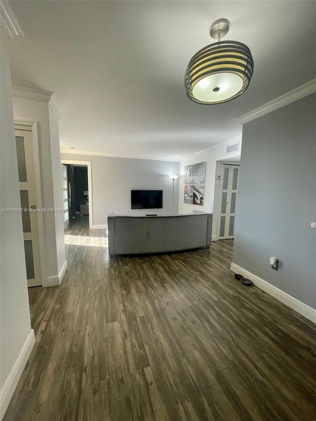 unfurnished living room featuring ornamental molding and dark hardwood / wood-style floors