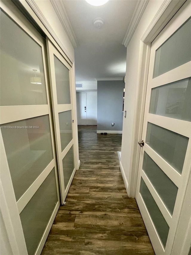 corridor featuring dark hardwood / wood-style flooring and crown molding