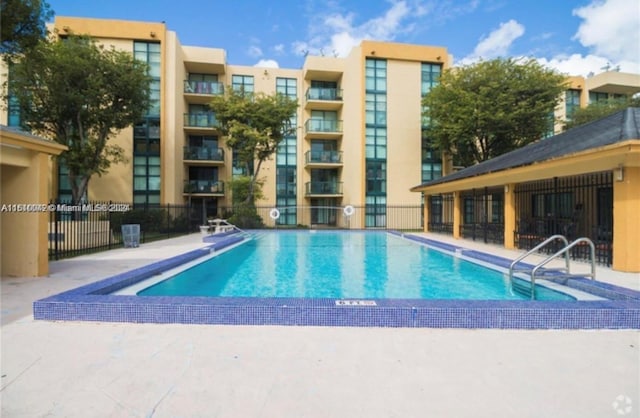 view of swimming pool with a patio area