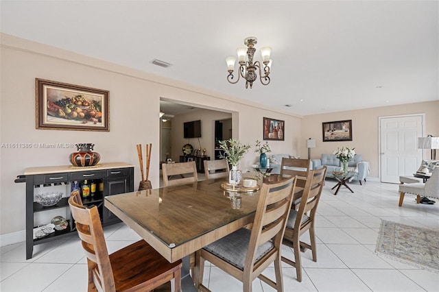 tiled dining space featuring a notable chandelier