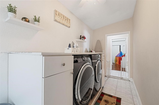 clothes washing area with washer and clothes dryer, light tile floors, and ceiling fan